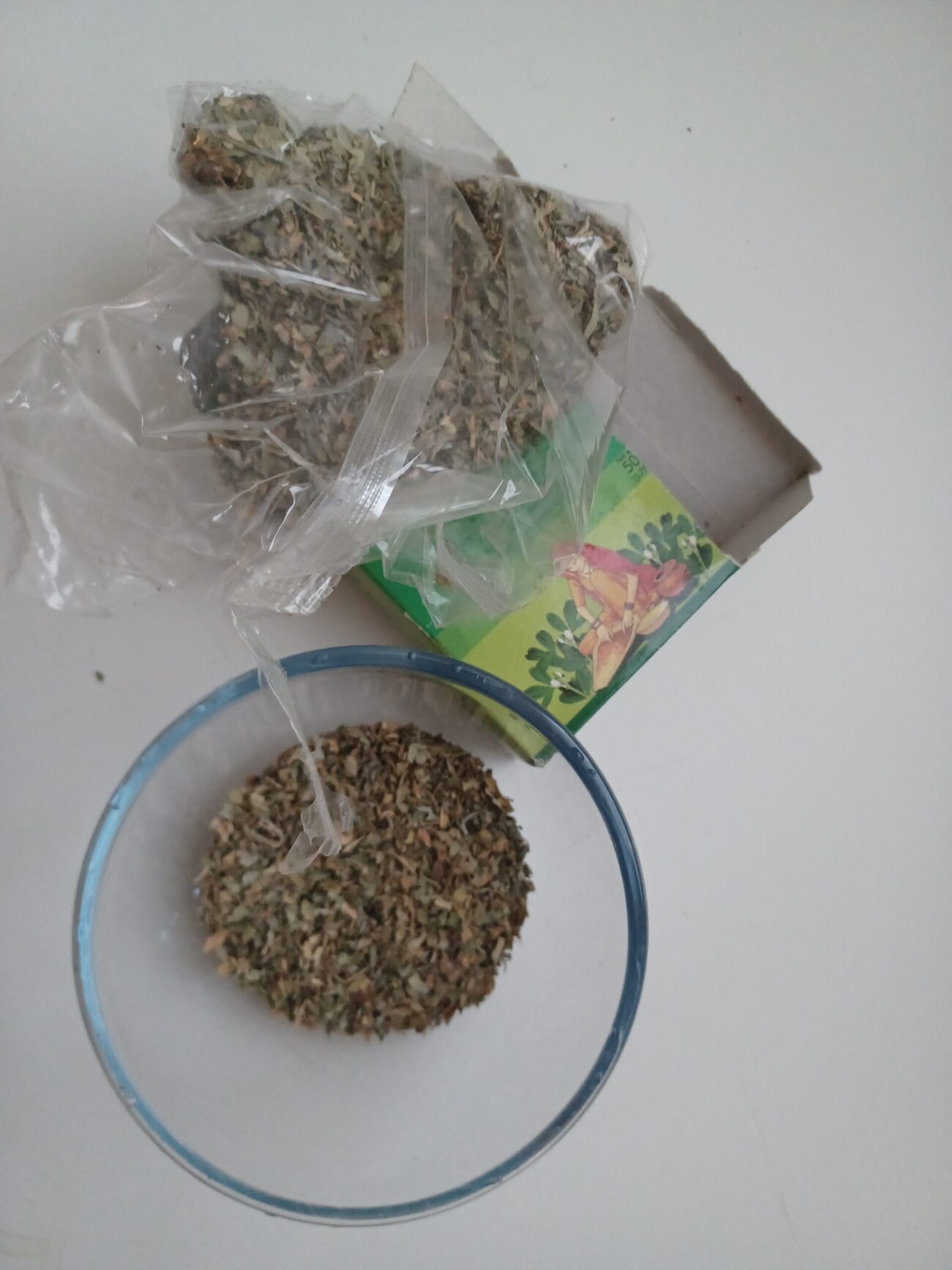 Serge's personal dried Trigonella foenum-graecum fenugreek leaves in glass bowl with packaging showing flavonoid vitamin and mineral rich leaf material distinct from seed tissue where furostanolic saponin and 4-hydroxyisoleucine compounds concentrate for hormonal and blood sugar effects