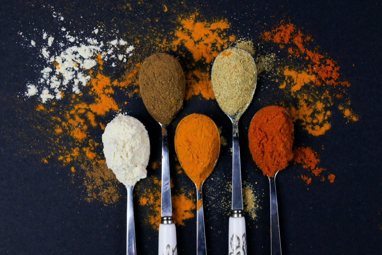 Ground medicinal spice powders including turmeric and ginger containing bioactive compounds curcumin and gingerols with documented anti-inflammatory and metabolic activity