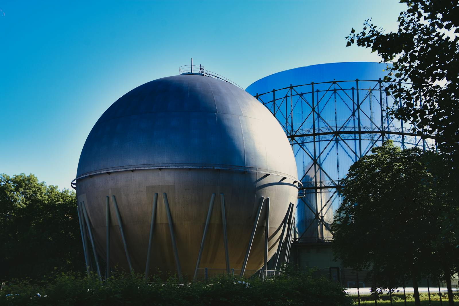 Large spherical biogas storage tanks at an industrial anaerobic digestion facility capturing methane from organic waste processing