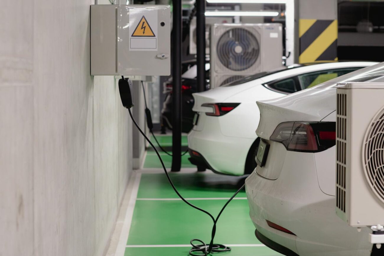 Electric vehicles charging in an underground parking facility with charging cables and electrical supply boxes