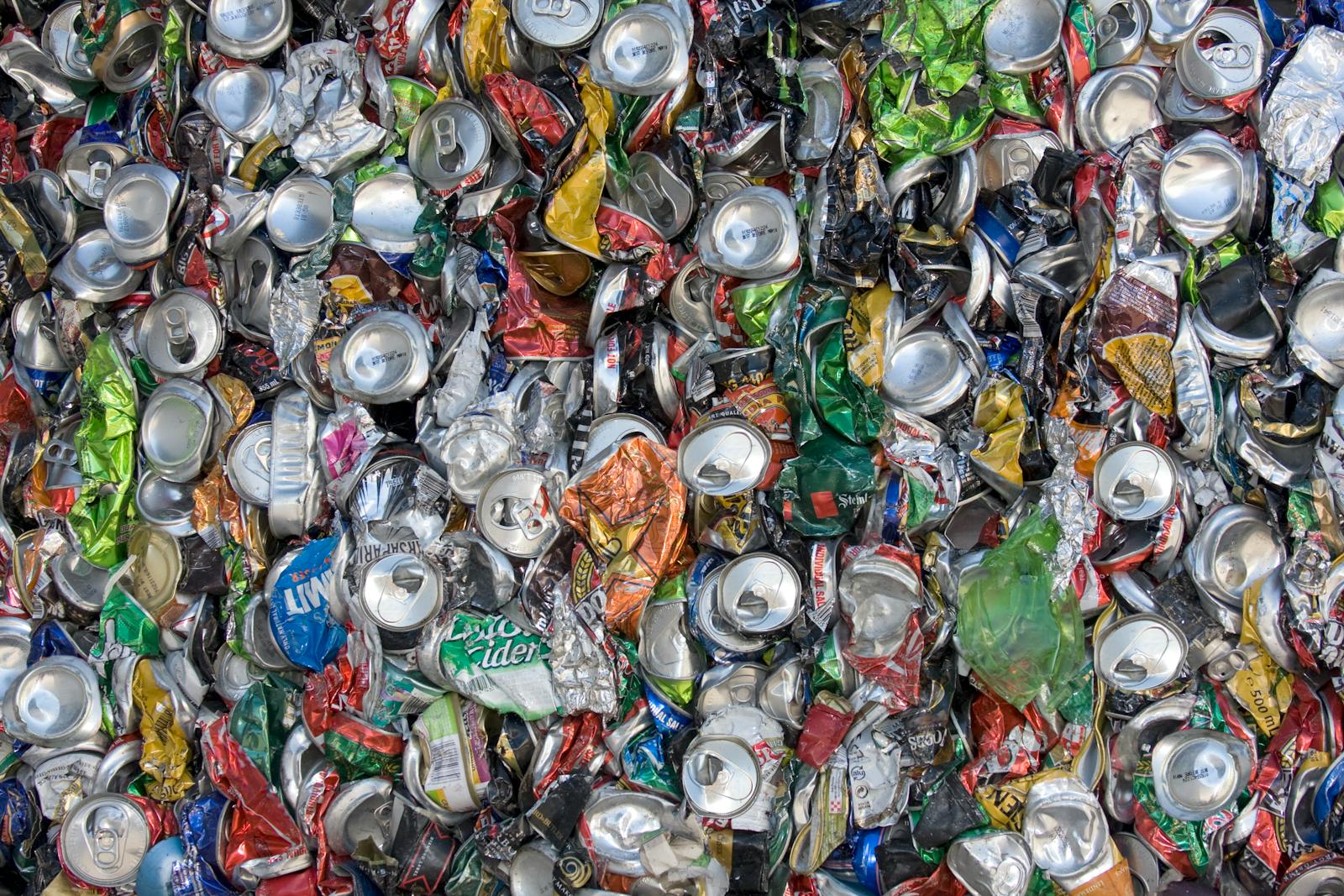 A large collection of crushed aluminium cans ready for recycling showing one of the most genuinely circular material recycling processes